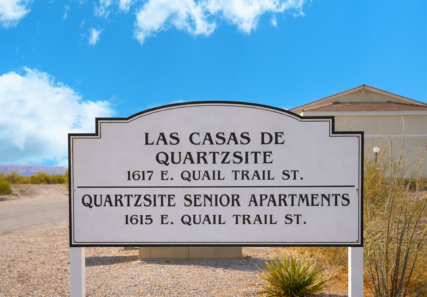 This image displays entrance marker photo of Quartzsite Senior Apartments